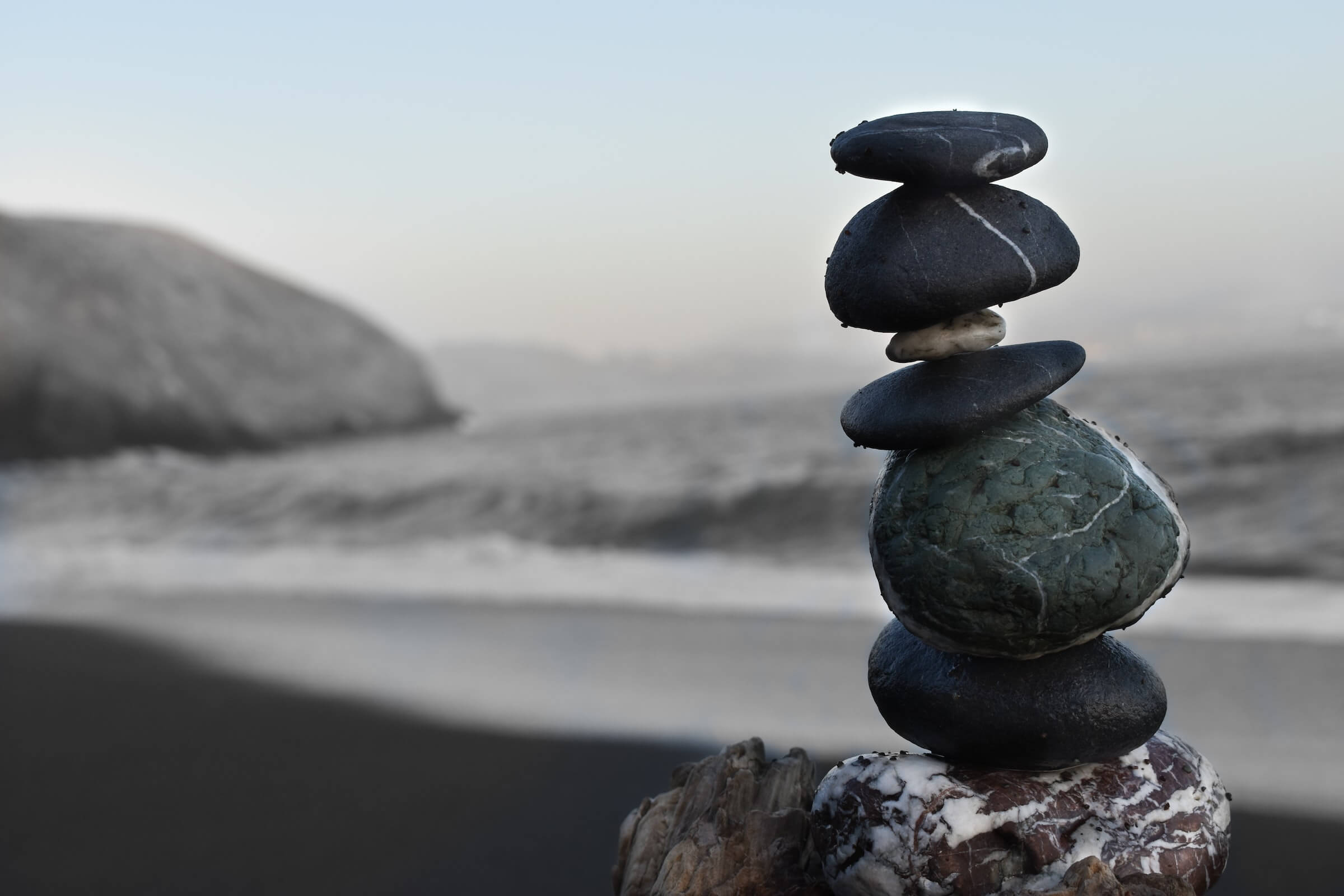 Positive money affirmations featured image of rocks stacked