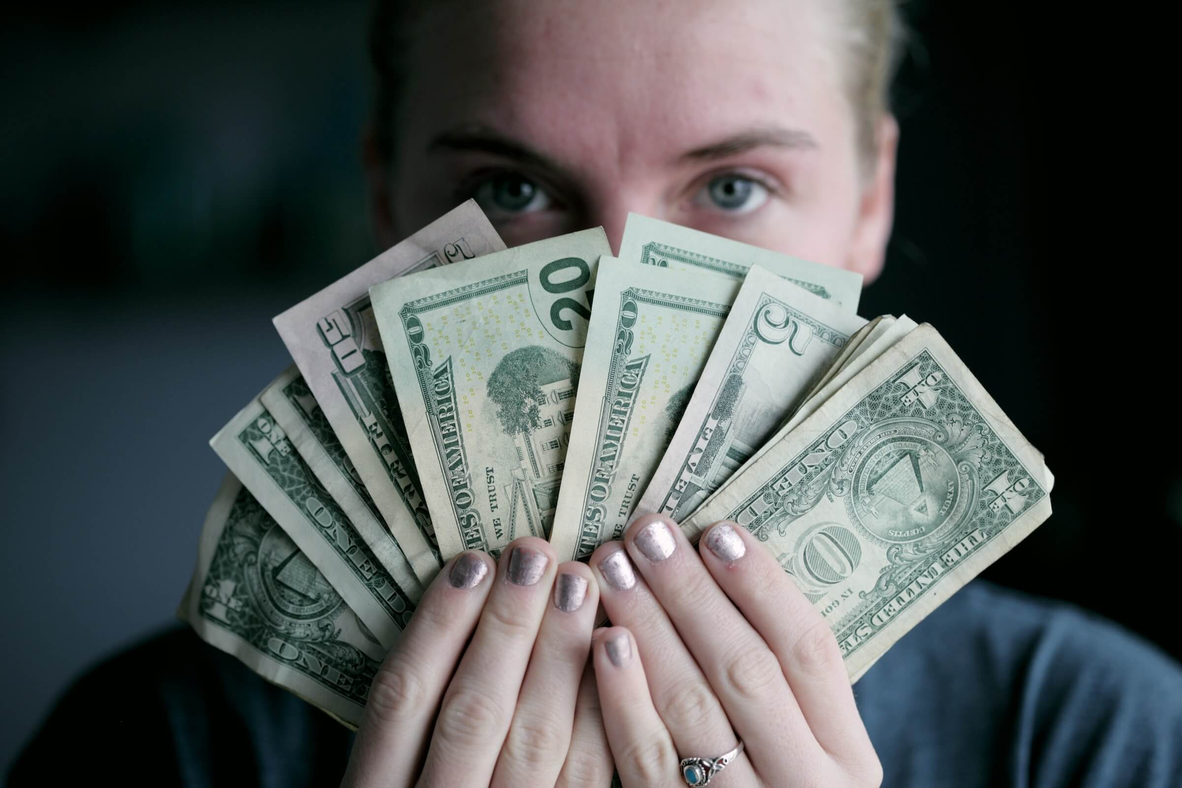Woman holding money after flipping money