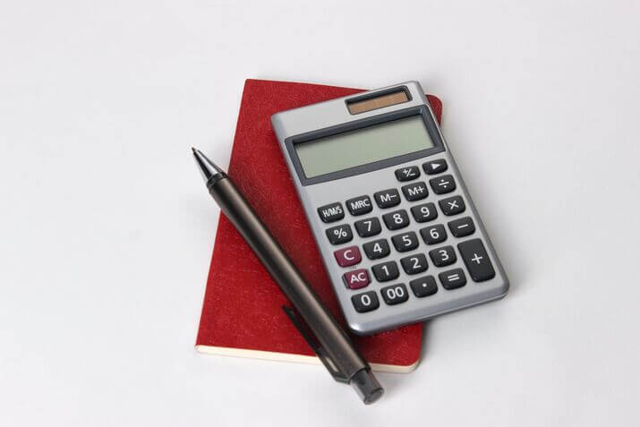Calculator and pen for budgeting